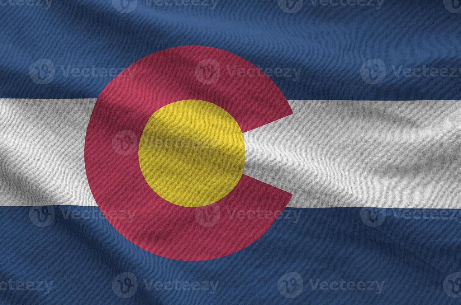 Colorado US state flag depicted on folded wavy fabric of old cloth photo