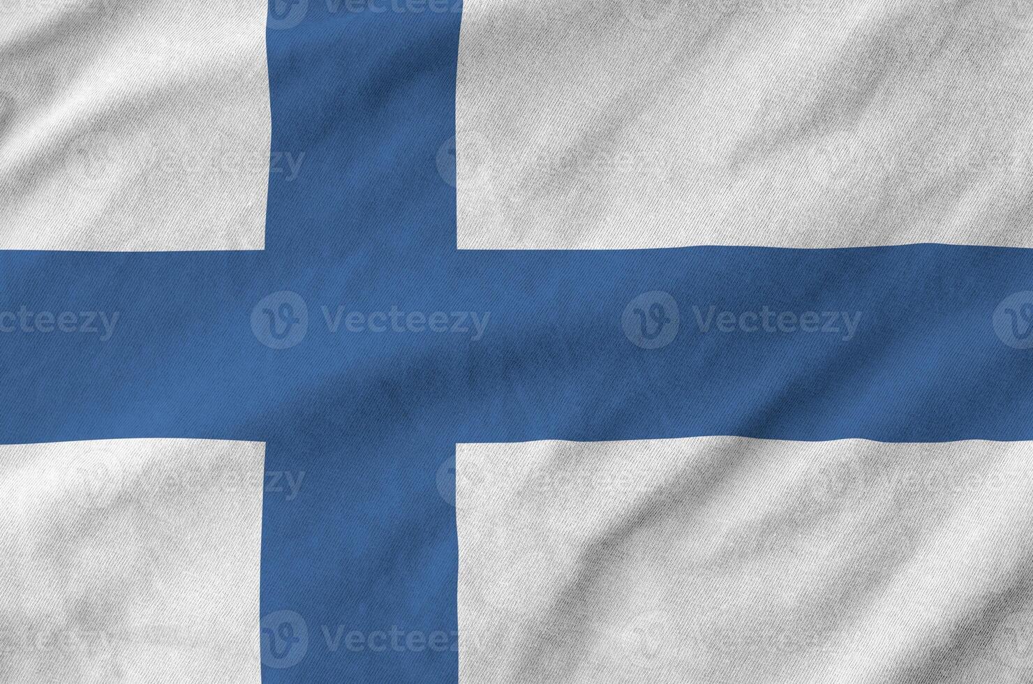 Finland flag depicted on folded wavy fabric of old cloth photo