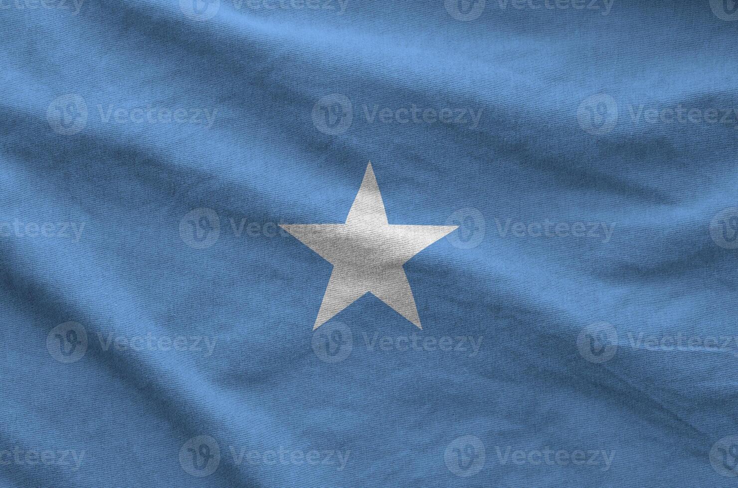 Somalia flag depicted on folded wavy fabric of old cloth photo