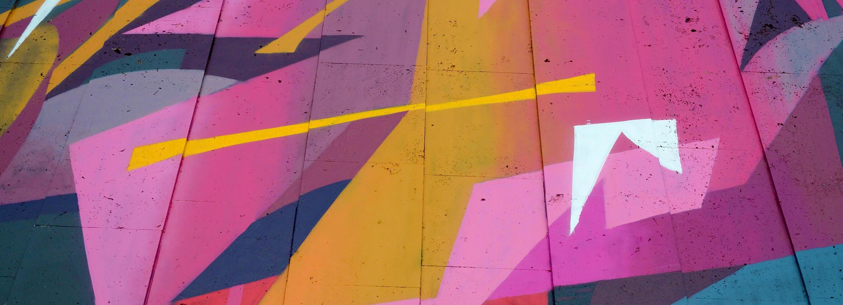 Colorful background of graffiti painting artwork with bright aerosol outlines on wall. Old school street art piece made with aerosol spray paint cans. Contemporary youth culture photo