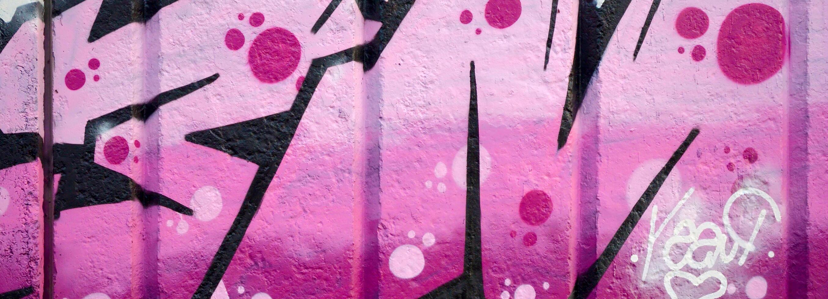 Colorful background of graffiti painting artwork with bright aerosol outlines on wall. Old school street art piece made with aerosol spray paint cans. Contemporary youth culture photo
