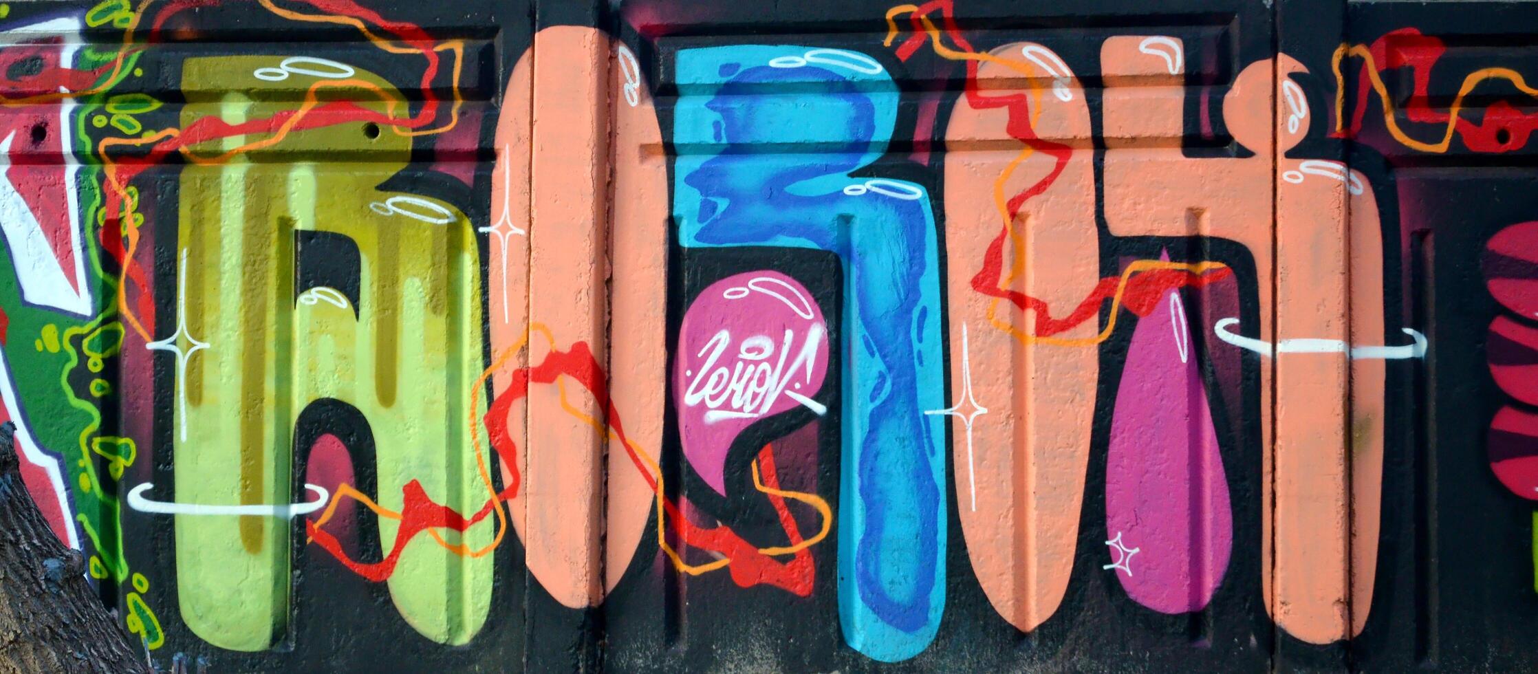 Colorful background of graffiti painting artwork with bright aerosol outlines on wall. Old school street art piece made with aerosol spray paint cans. Contemporary youth culture photo