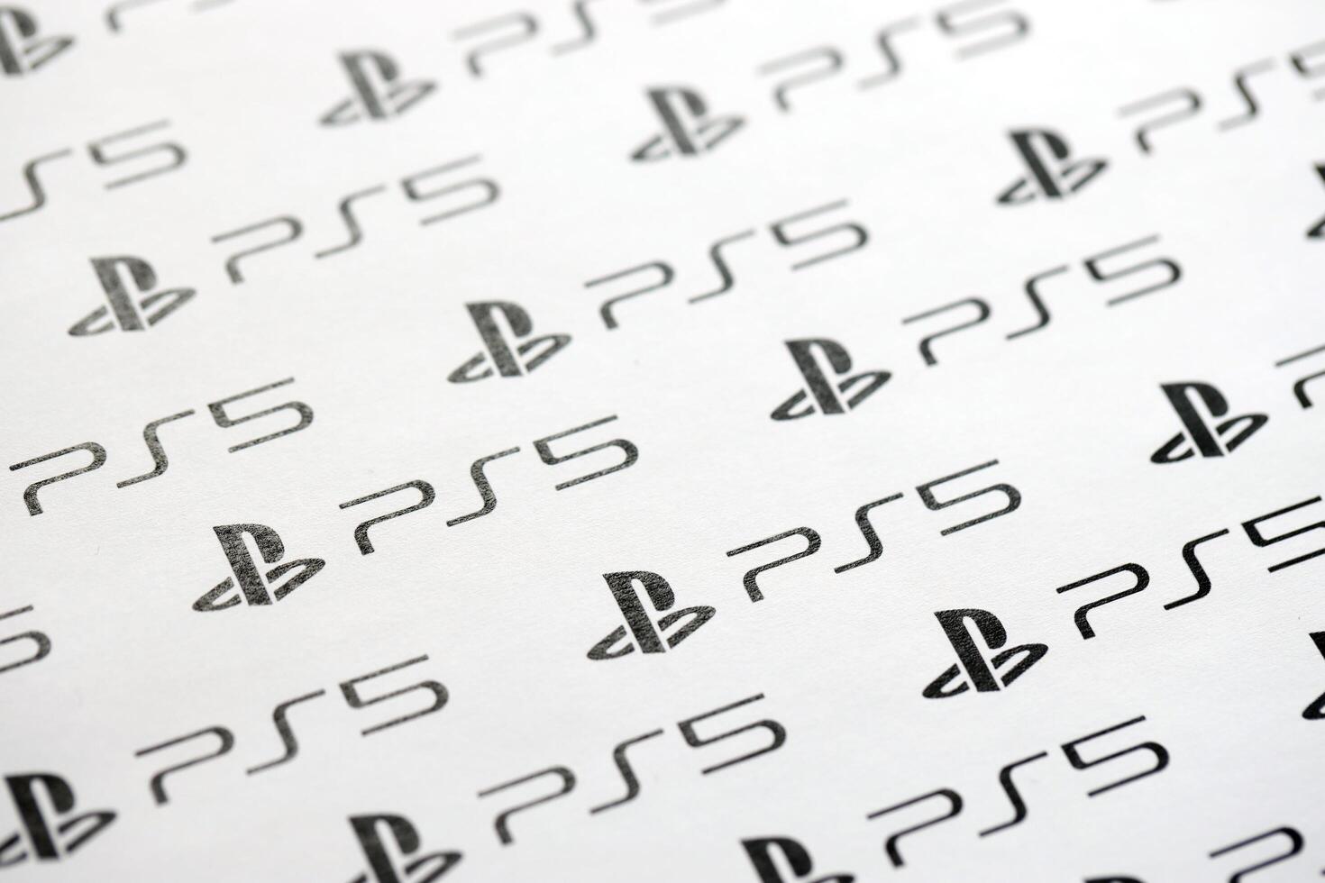 KYIV, UKRAINE - JUNE 26, 2024 Sony Playstation 5 console logo repeating many times on white paper background banner photo