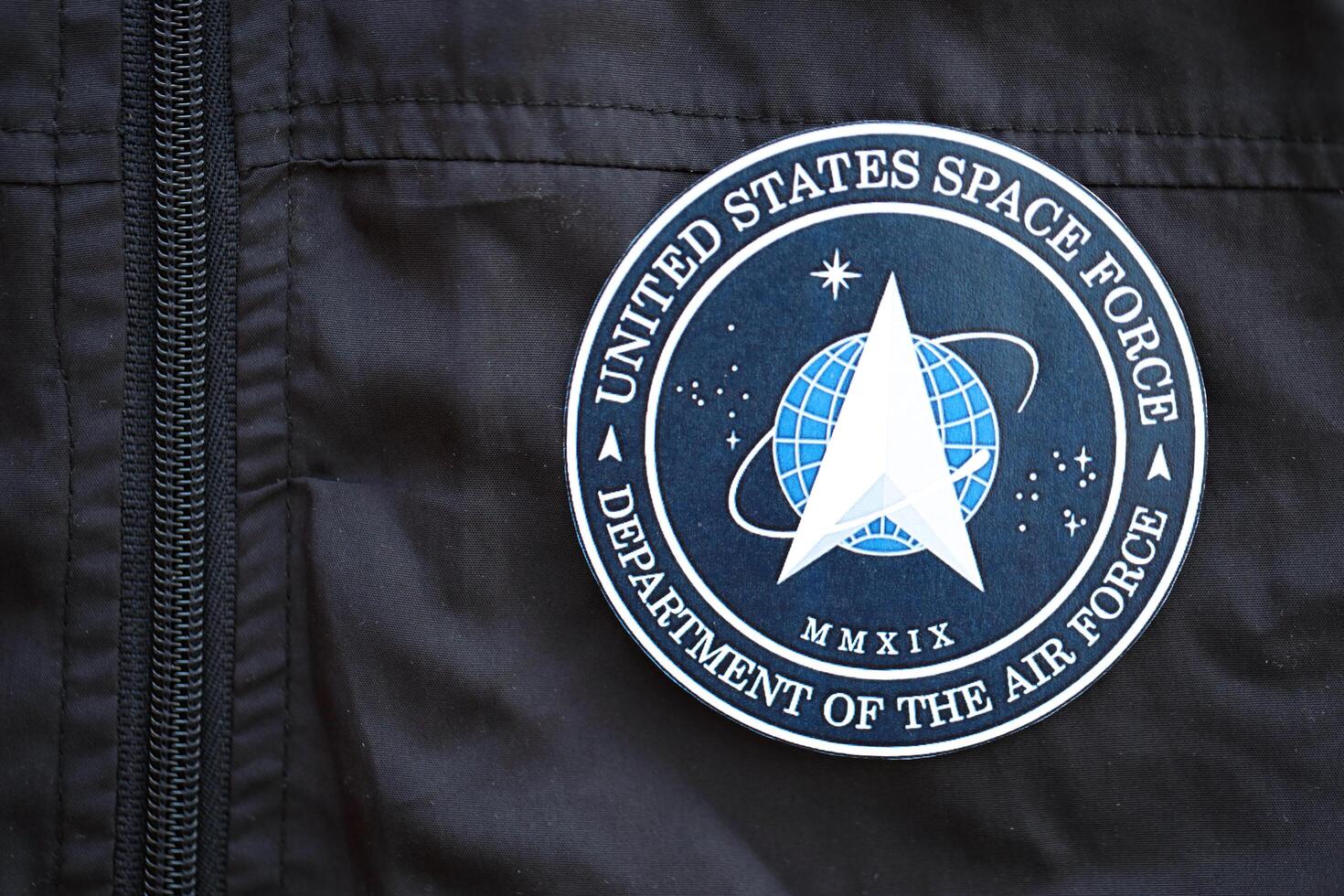 KYIV, UKRAINE - JUNE 26, 2024 United States Space Force Department of the Air Force coat of arms as pin on black uniform jacket photo
