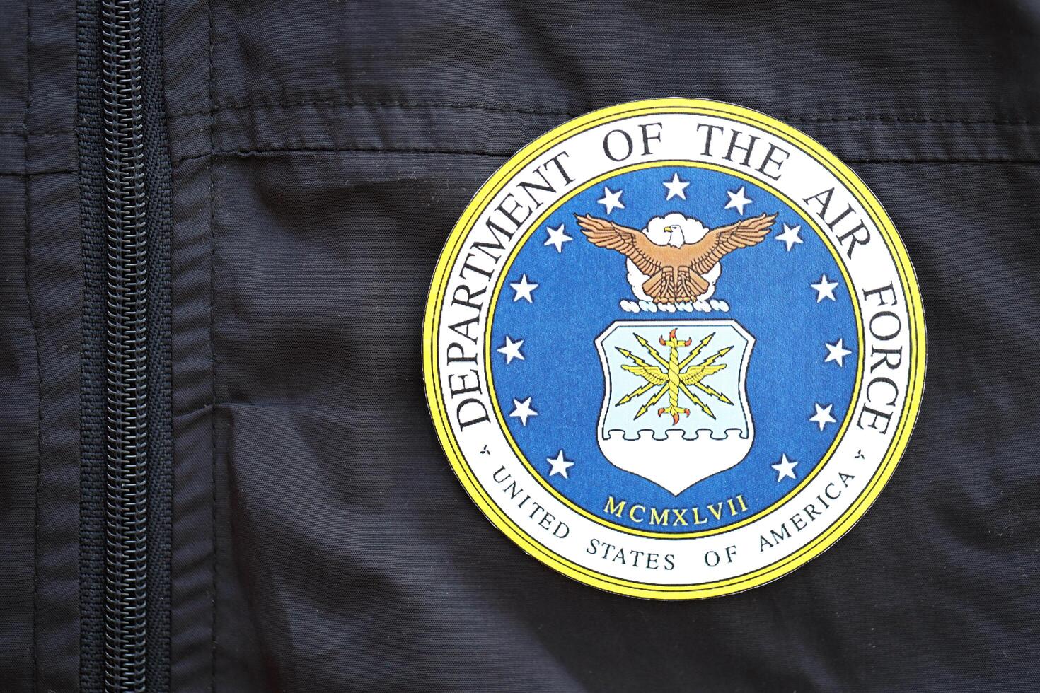 KYIV, UKRAINE - JUNE 26, 2024 United States Department of the Air Force coat of arms as pin on black uniform jacket photo