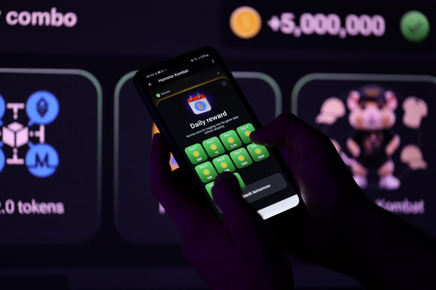 KYIV, UKRAINE - APRIL 20, 2024 Hamster Kombat telegram bot on smartphone screen. Hamster Kombat is a viral Telegram-based crypto game for earn HMSTR tokens by managing virtual crypto exchange photo