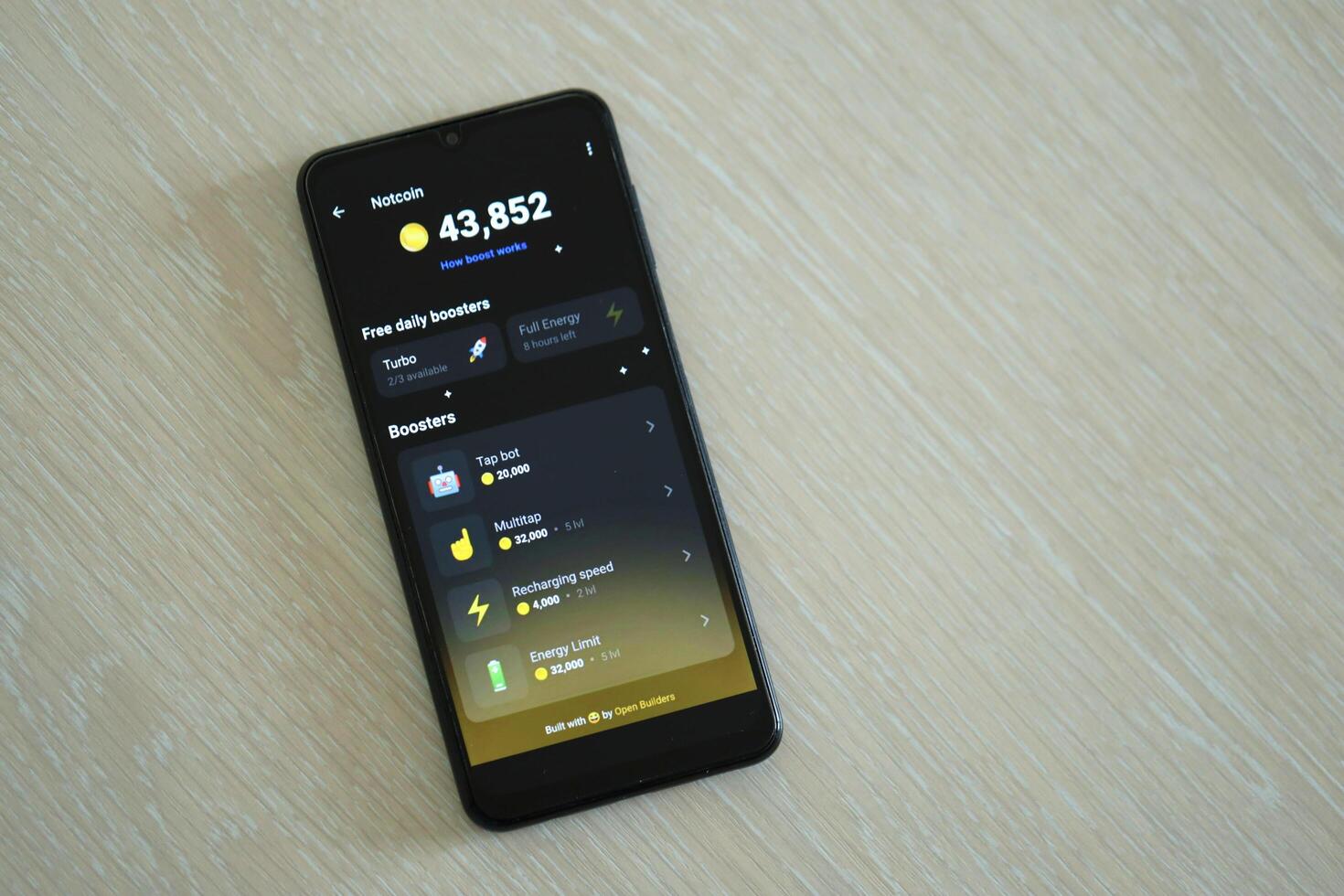 KYIV, UKRAINE - APRIL 20, 2024 Notcoin telegram bot on smartphone screen. Notcoin is a viral Telegram based crypto game for earn tokens by managing virtual crypto exchange photo