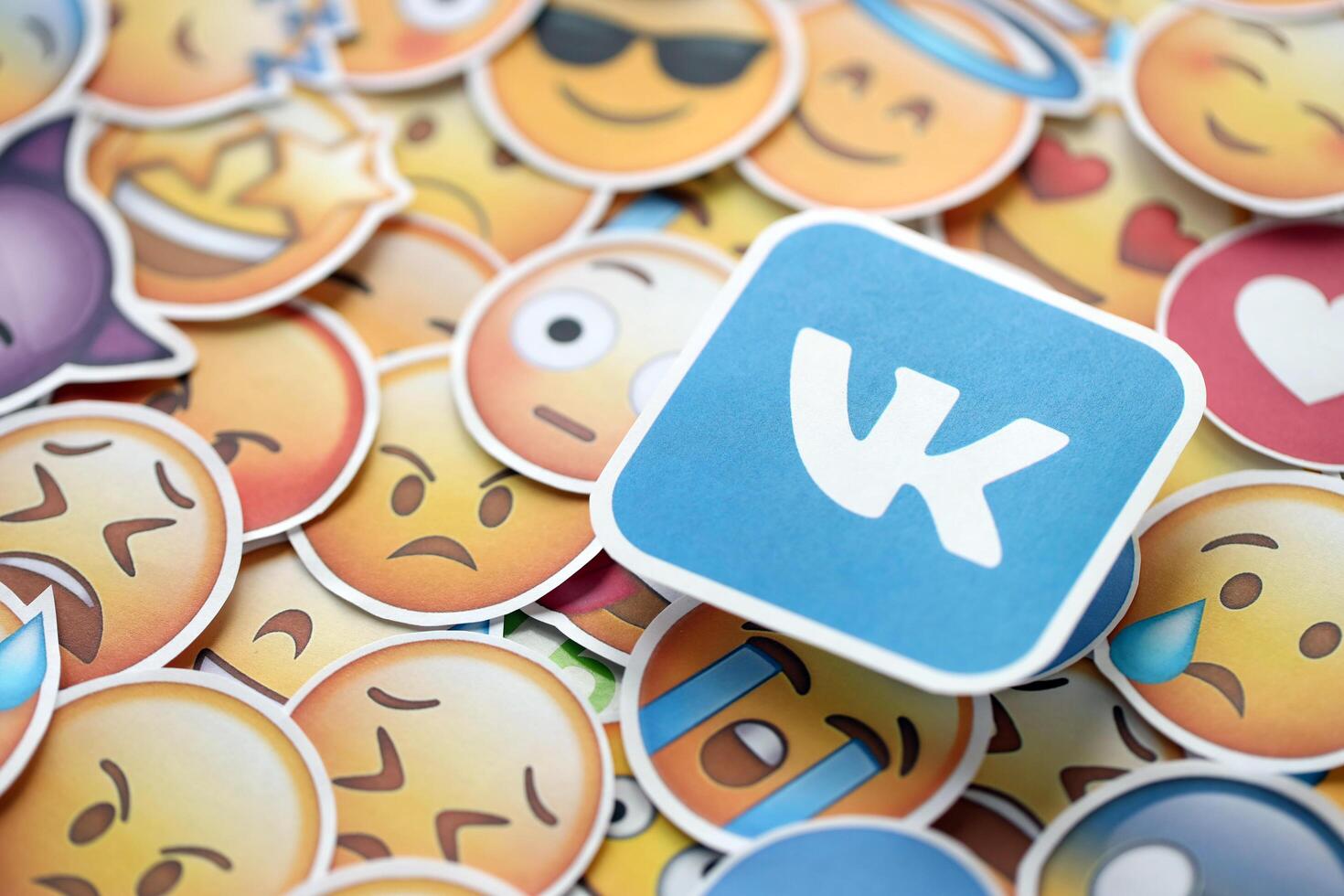 KYIV, UKRAINE - APRIL 20, 2024 VK logo and large set of stickers with Emoji yellow faces. Emoji is a pictogram or smiley embedded in text and used in electronic messages photo