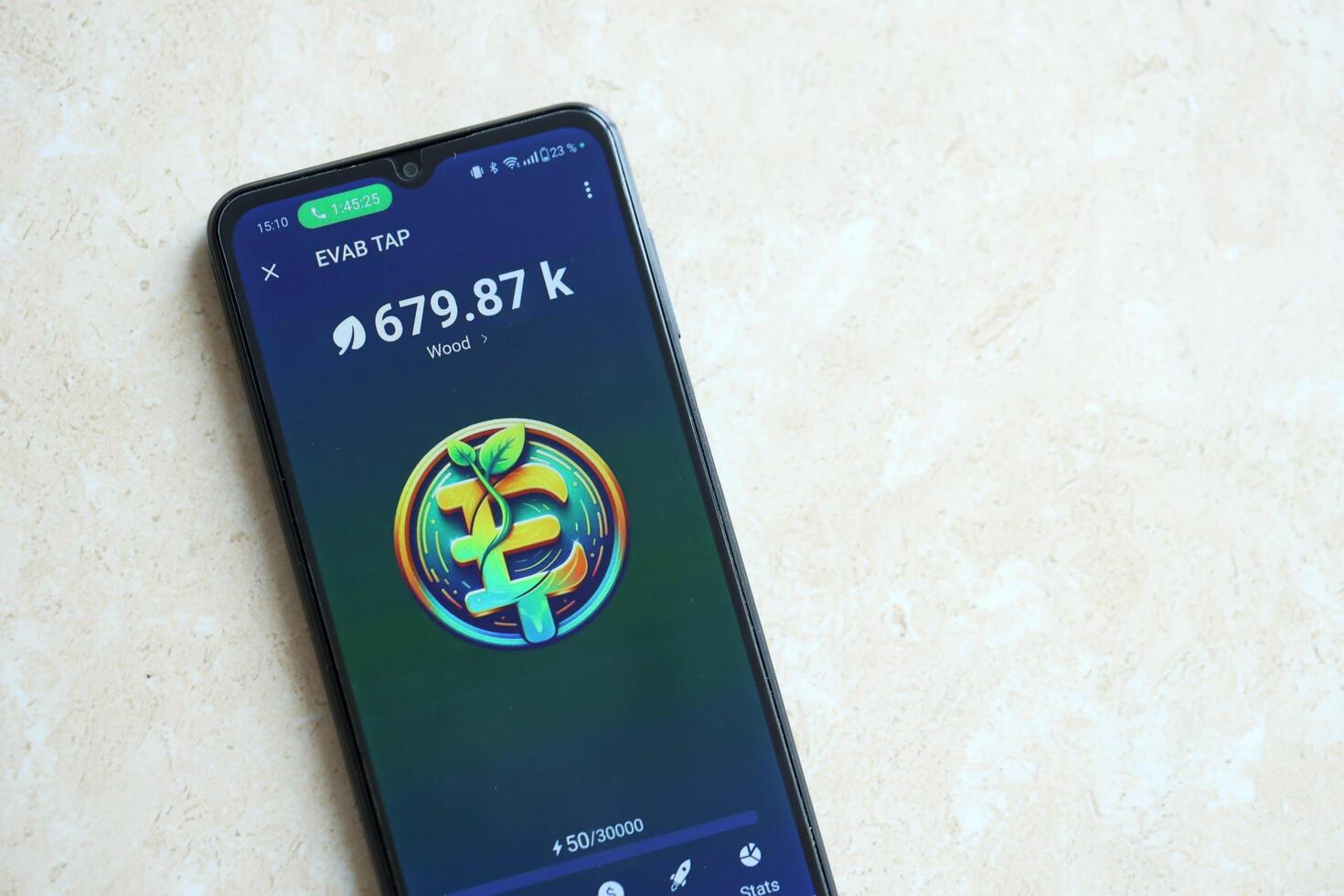 KYIV, UKRAINE - APRIL 20, 2024 EVAB TAP telegram bot on smartphone screen. EVAB TAP is a viral Telegram based crypto game for earn tokens by managing virtual crypto exchange photo