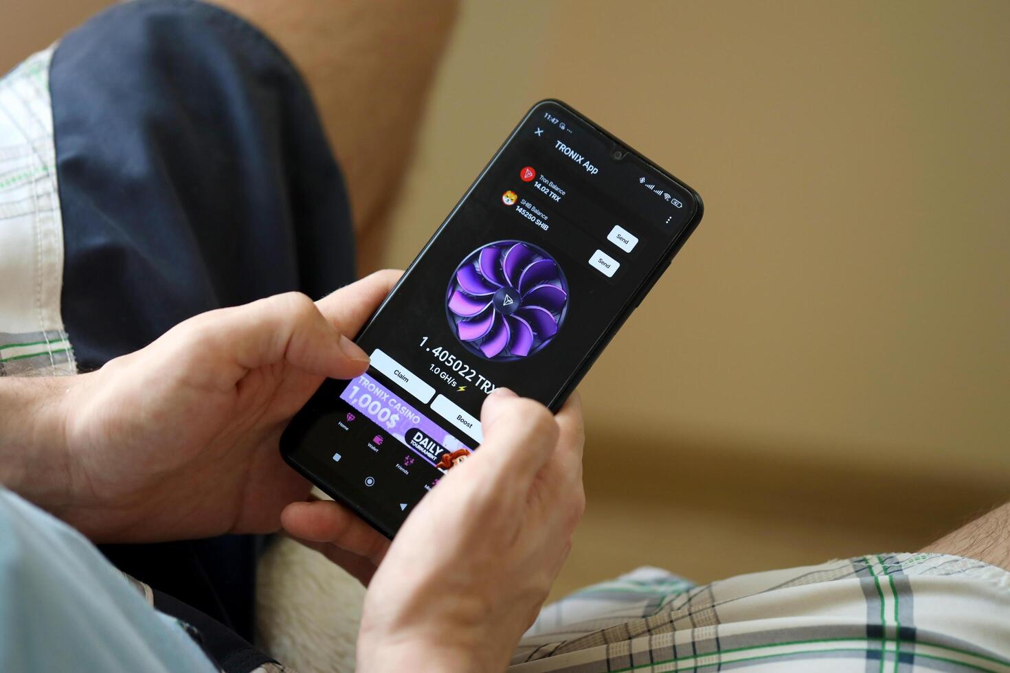 KYIV, UKRAINE - APRIL 20, 2024 Tronix App telegram bot on smartphone screen. Tronix App is a viral Telegram based crypto game for earn TRX tokens by managing virtual crypto exchange photo