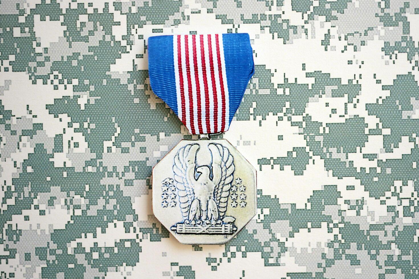 KYIV, UKRAINE - JULY 10, 2024 US Non-Combat Heroism Soldiers medal. United States military award medal with ribbon and pin. Handmade paper theater props photo