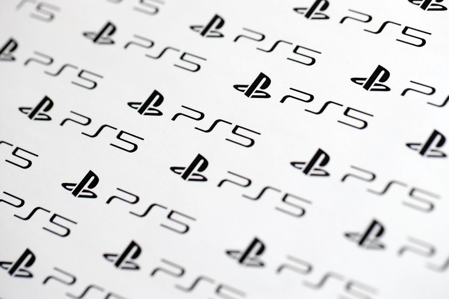 KYIV, UKRAINE - JUNE 26, 2024 Sony Playstation 5 console logo repeating many times on white paper background banner photo