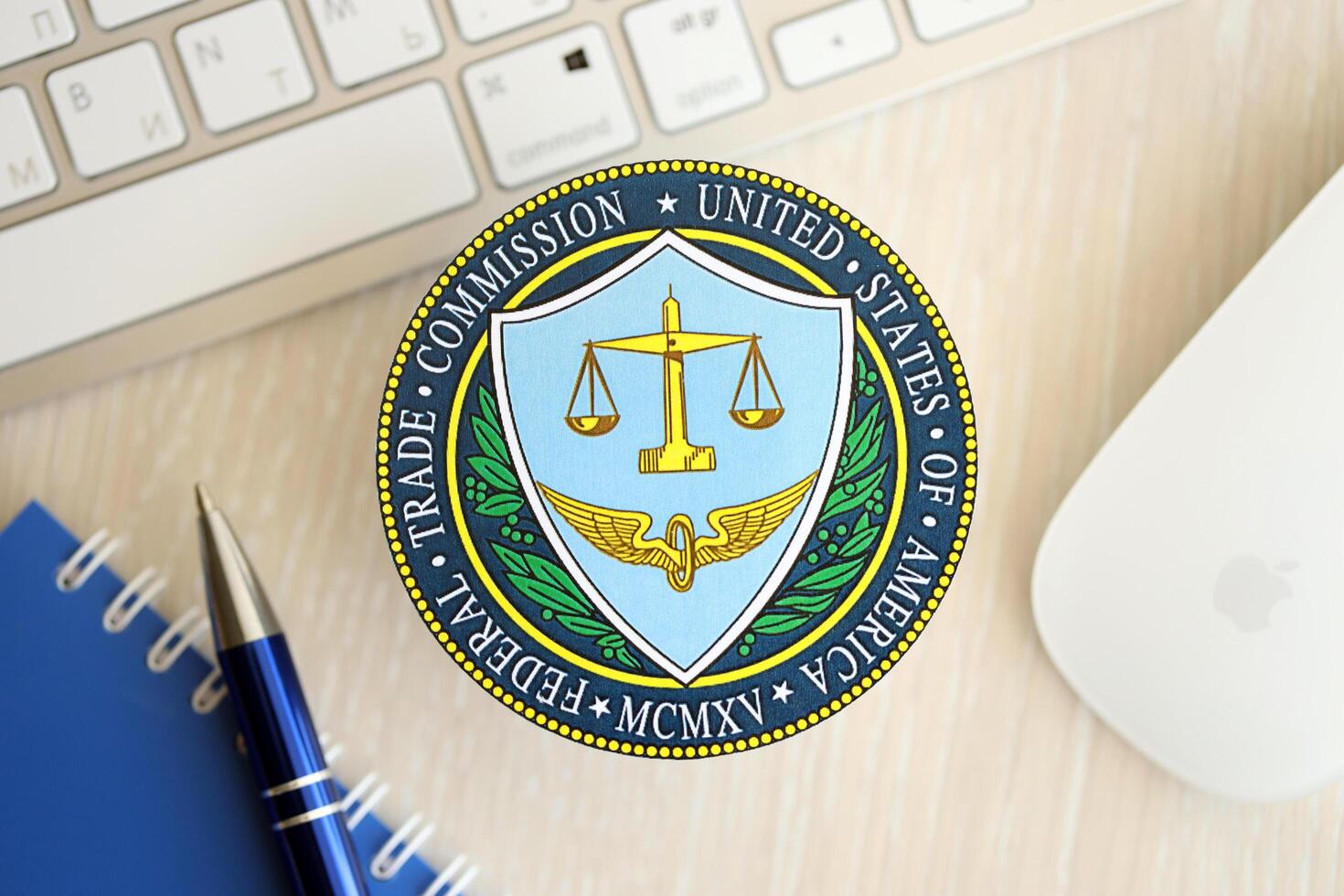 KYIV, UKRAINE - JUNE 26, 2024 United States Federal Trade Commission coat of arms sticker on workers office table photo