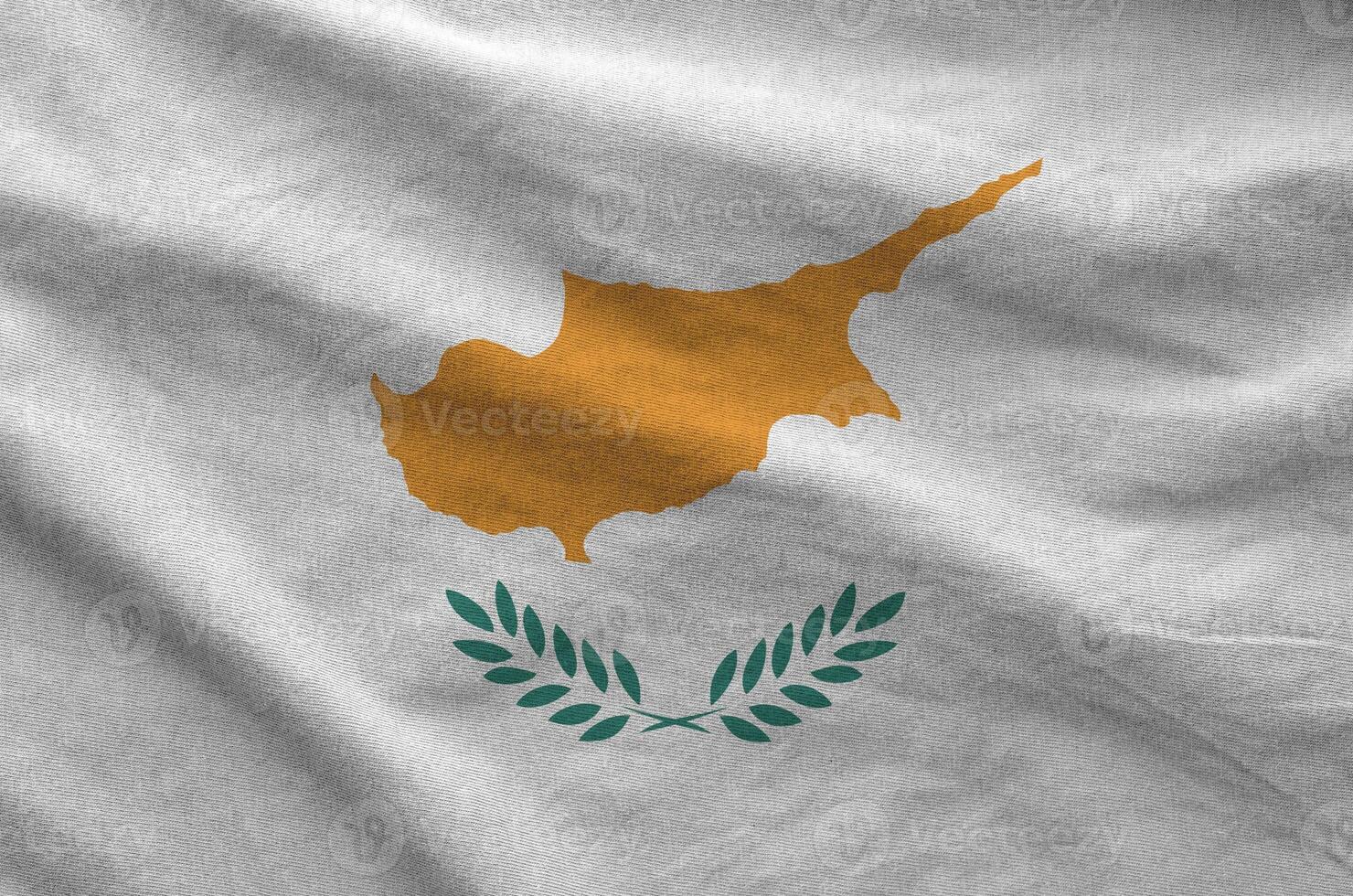 Cyprus flag depicted on folded wavy fabric of old cloth photo