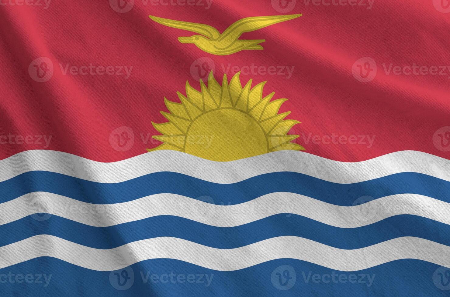 Kiribati flag depicted on folded wavy fabric of old cloth photo
