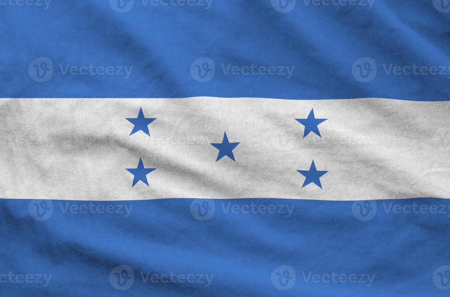 Honduras flag depicted on folded wavy fabric of old cloth photo