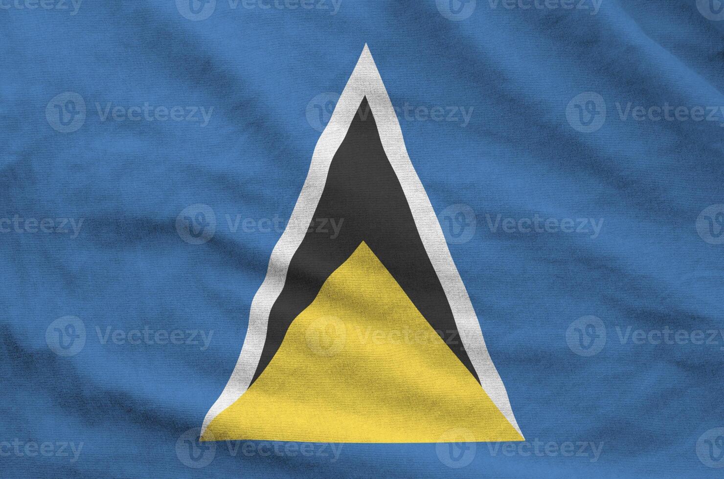 Saint Lucia flag depicted on folded wavy fabric of old cloth photo