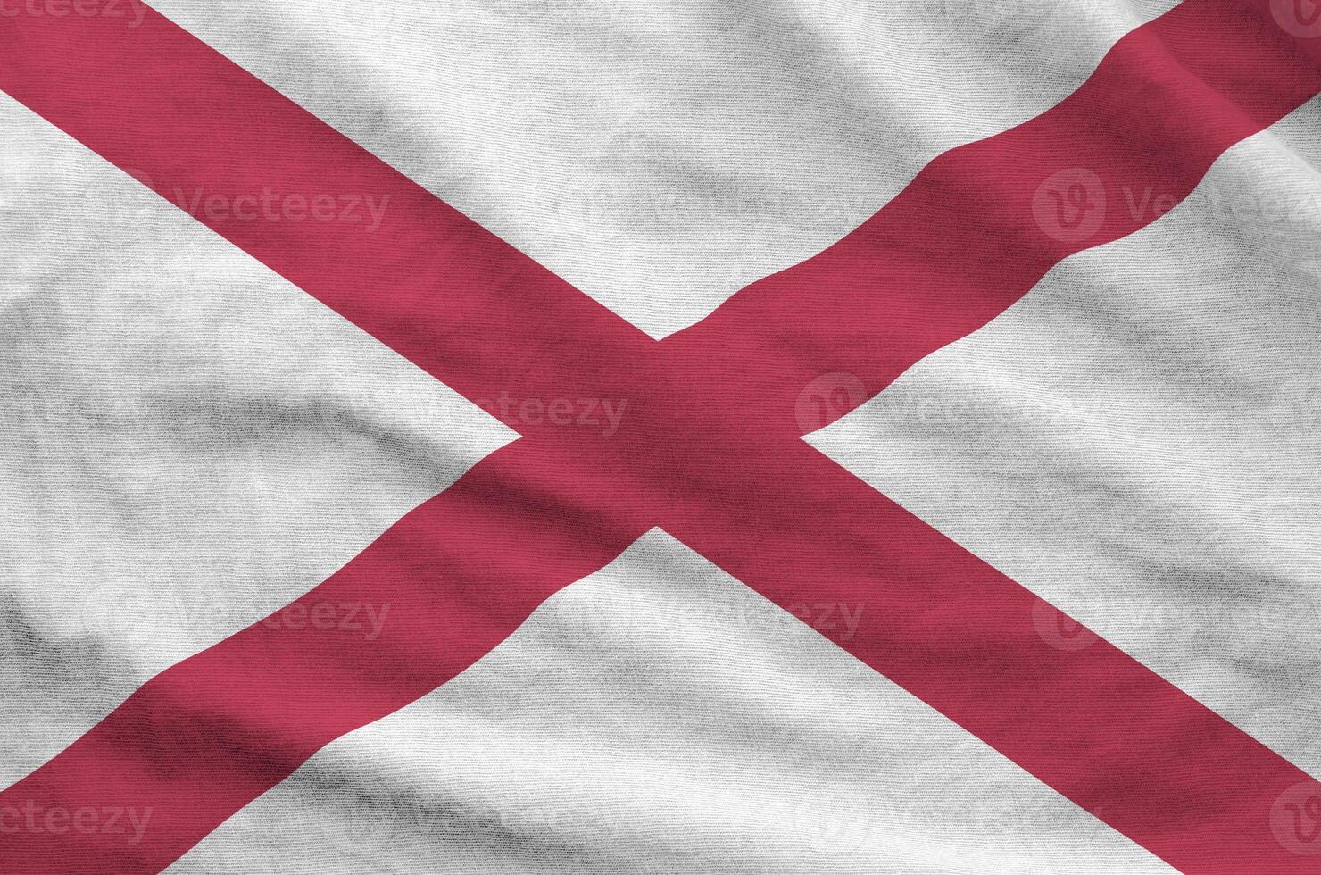 Alabama US state flag depicted on folded wavy fabric of old cloth photo