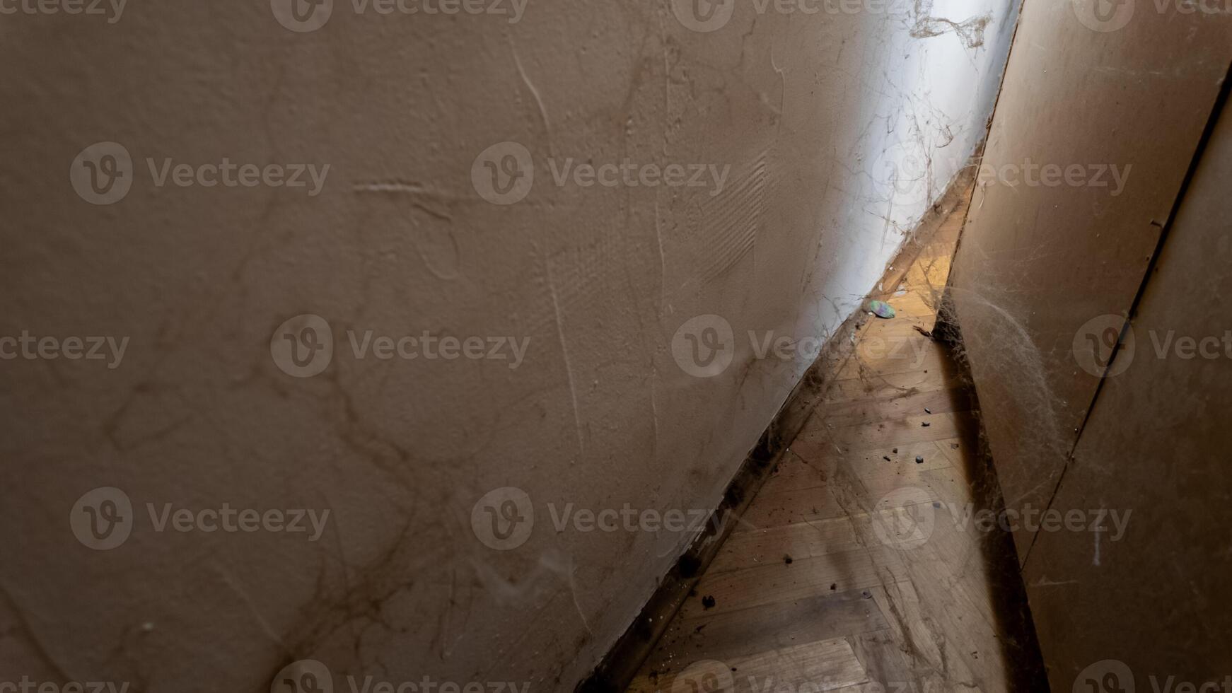 Abandoned, cobweb filled corner of a dusty room highlighting neglect and the need for spring cleaning or household maintenance photo