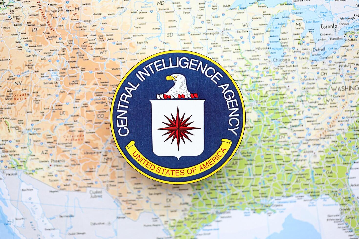 KYIV, UKRAINE - JUNE 26, 2024 United States of America Central Intelligence Agency coat of arms on paper map of United States photo