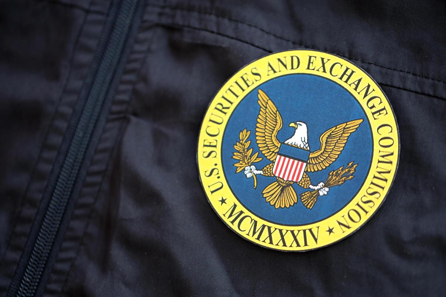 KYIV, UKRAINE - JUNE 26, 2024 U.S. Securities and Exchange Commission coat of arms as pin on black uniform jacket photo