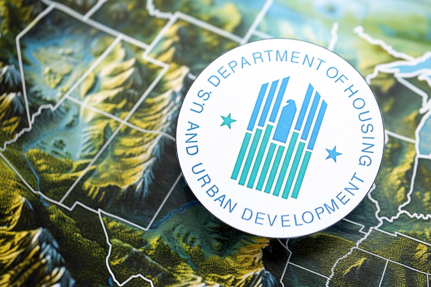 KYIV, UKRAINE - JUNE 26, 2024 U.S. Department of Housing and Urban Development coat of arms on paper map of United States photo