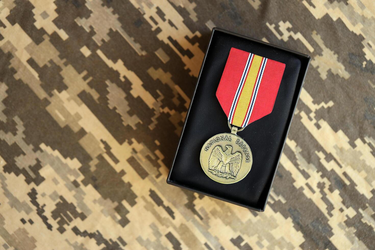 KYIV, UKRAINE - JULY 10, 2024 National Defense General Service medal. United States military award medal with ribbon and pin. Handmade paper theater props photo