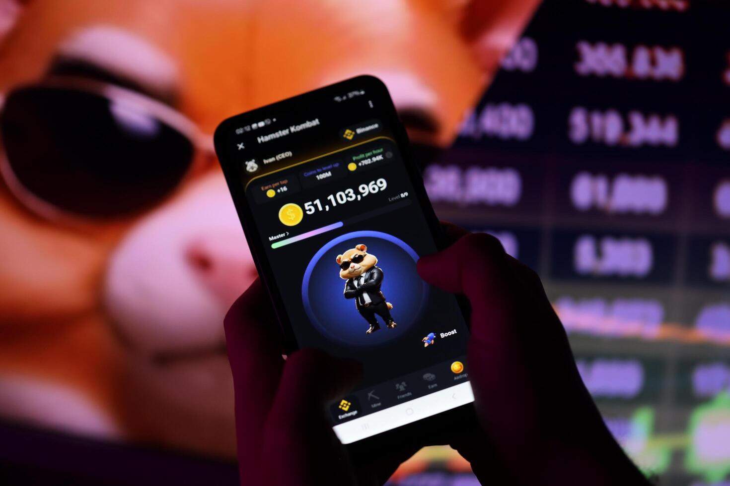 KYIV, UKRAINE - APRIL 20, 2024 Hamster Kombat telegram bot on smartphone screen. Hamster Kombat is a viral Telegram-based crypto game for earn HMSTR tokens by managing virtual crypto exchange photo