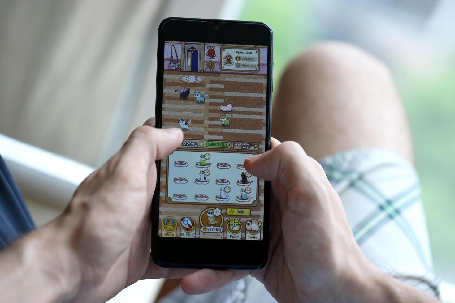 KYIV, UKRAINE - APRIL 20, 2024 Catizen telegram bot on smartphone screen. Catizen is a viral Telegram based crypto game for earn tokens by managing virtual crypto exchange photo