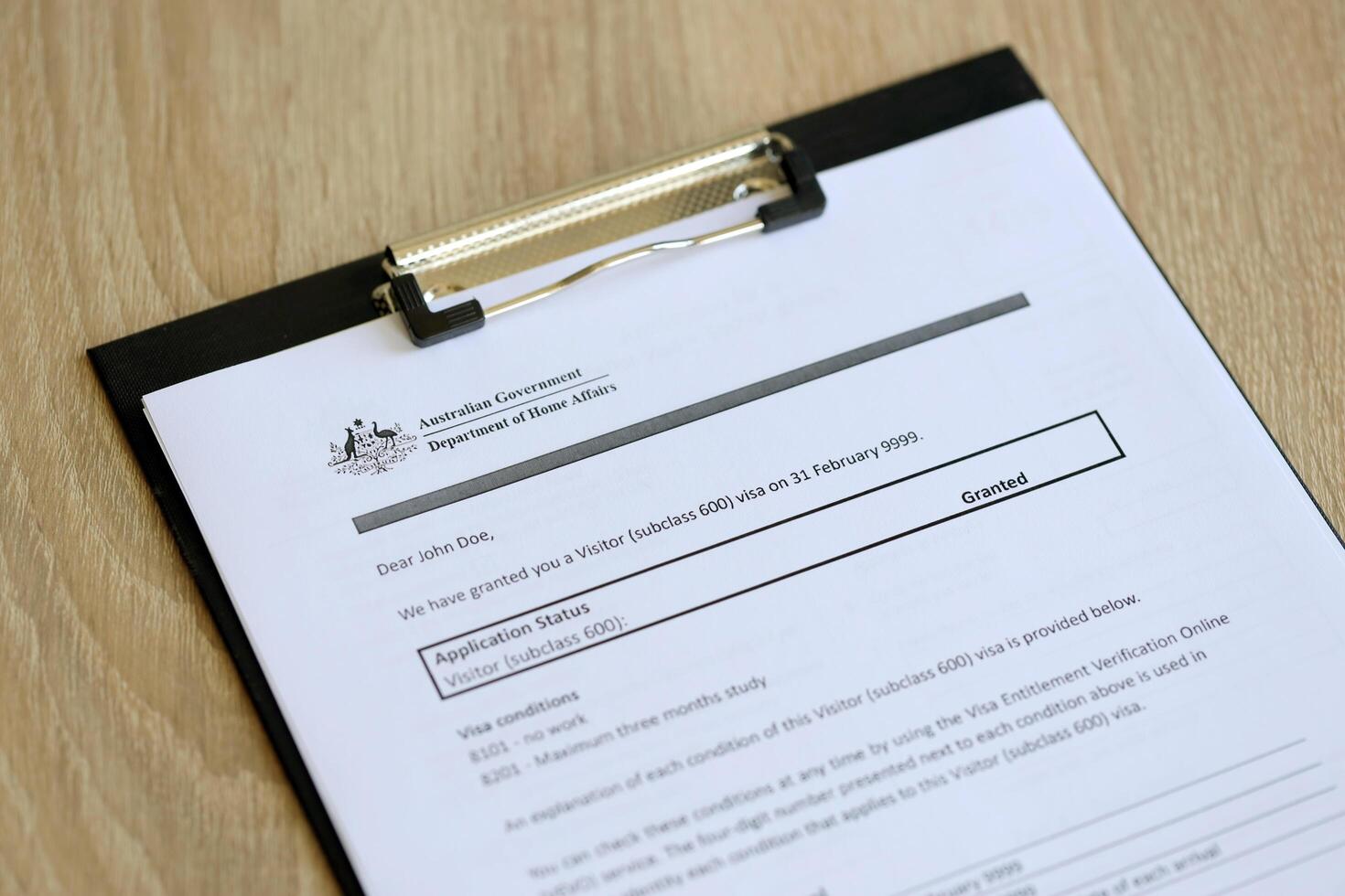 KYIV, UKRAINE - JULY 10, 2024 Application status for Australian visitor visa on table of Australian Government Department of Home Affairs photo