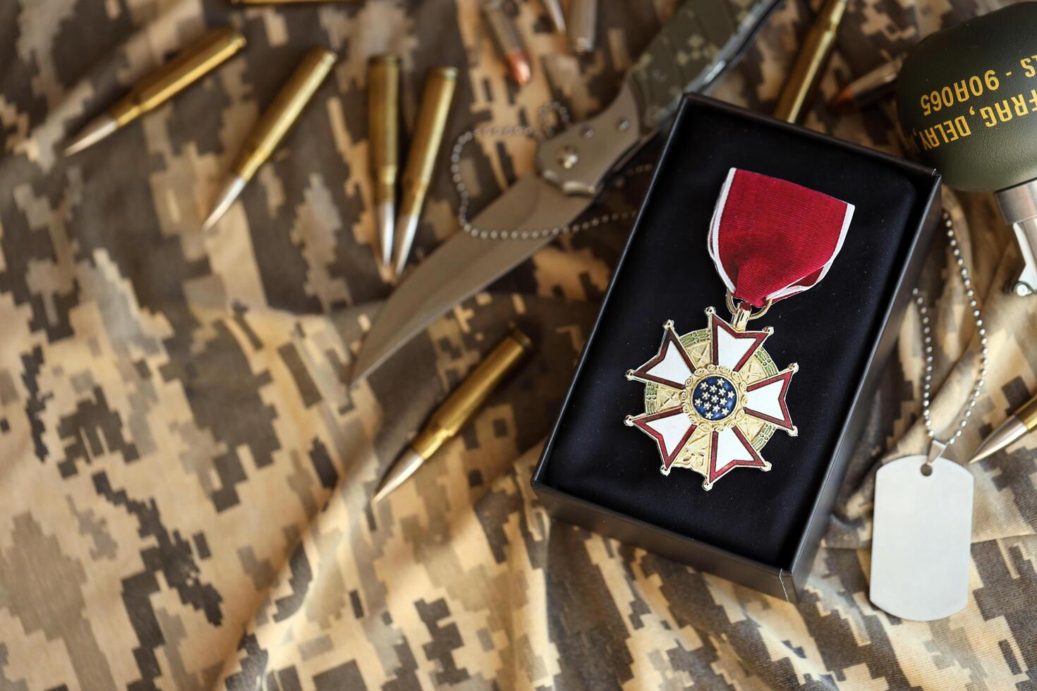 KYIV, UKRAINE - JULY 10, 2024 US Legion of Merit medal. United States military award medal with ribbon and pin. Handmade paper theater props photo