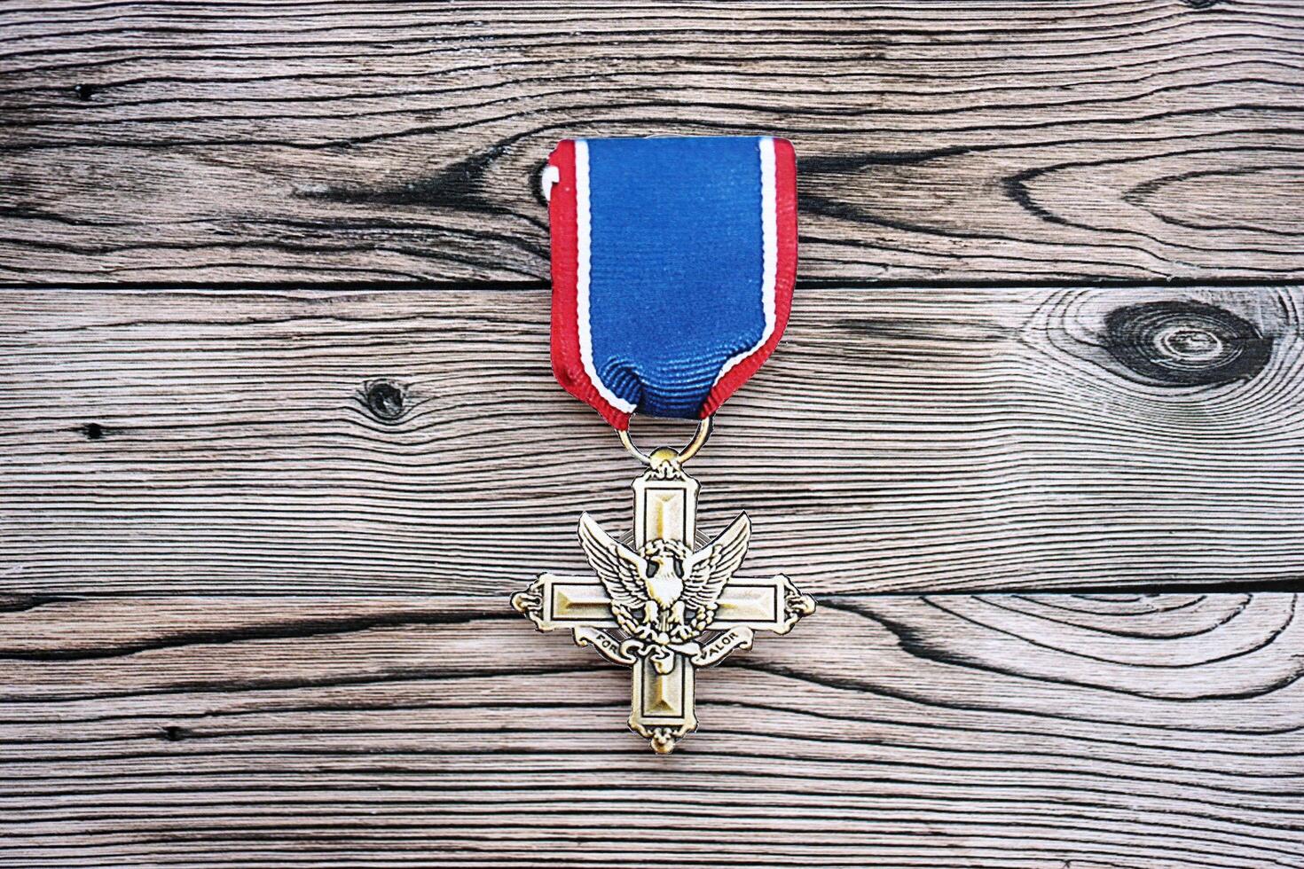 KYIV, UKRAINE - JULY 10, 2024 Distinguished Service Cross medal. United States military award medal with ribbon and pin. Handmade paper theater props photo