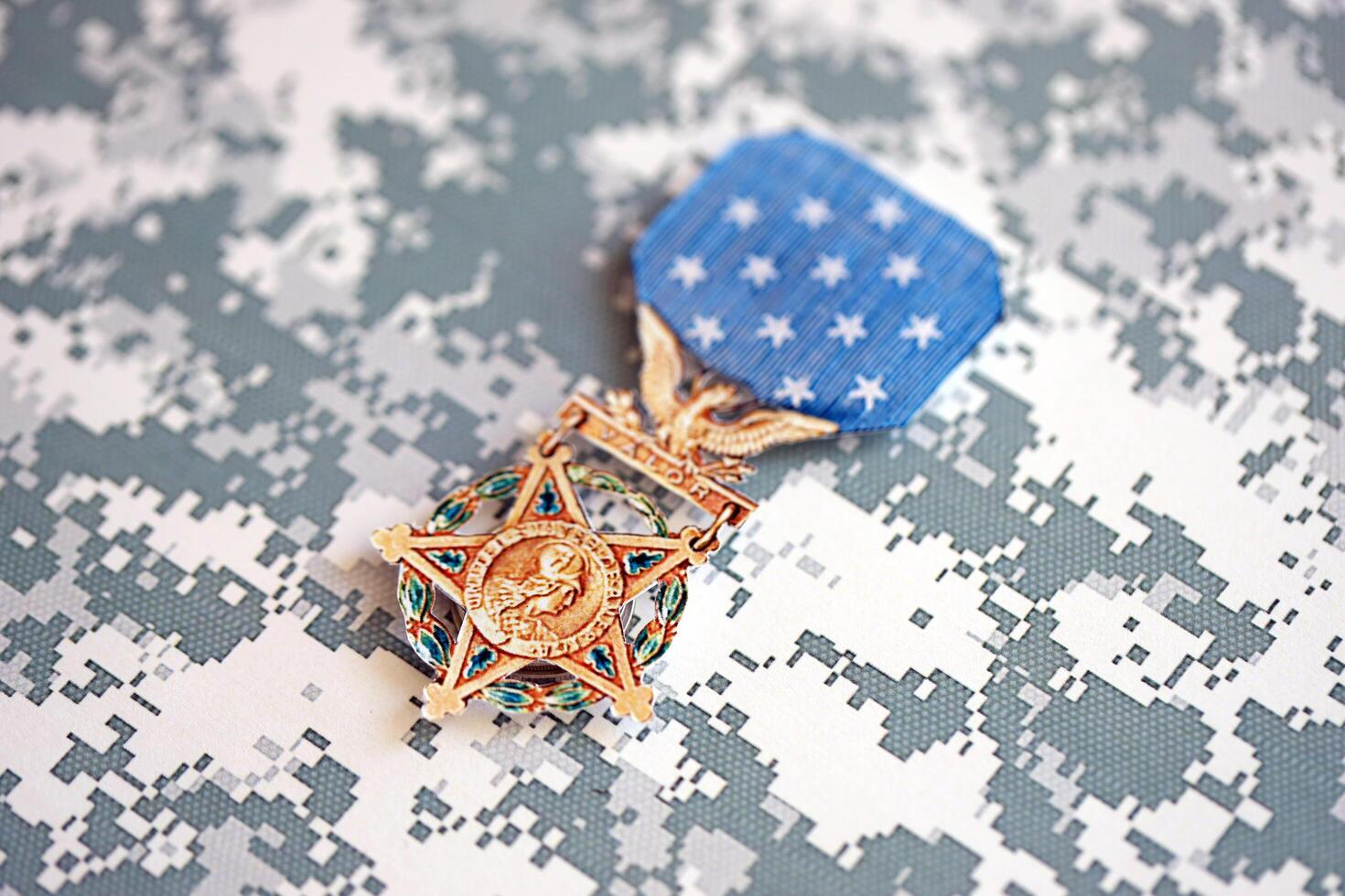 KYIV, UKRAINE - JULY 10, 2024 US Army Medal Of Honor. Highest United States military award medal with ribbon and pin. Handmade paper theater props photo