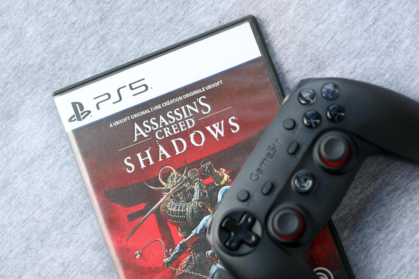 KYIV, UKRAINE - JUNE 26, 2024 Assassin's Creed Shadows PS5 game disc box for console gaming. Popular game disc photo