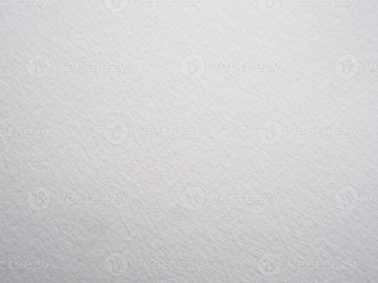 Grungy white watercolor paper backdrop with rough textured surface for design projects photo