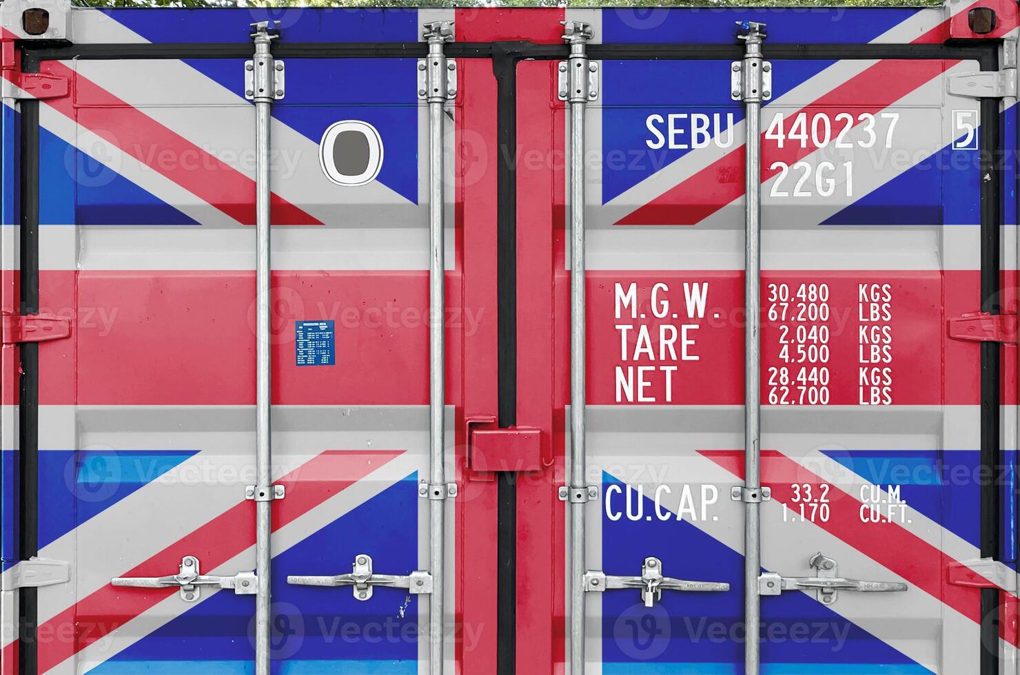 Great britain flag depicted on metal doors of shipping cargo container outdoors in docks area photo