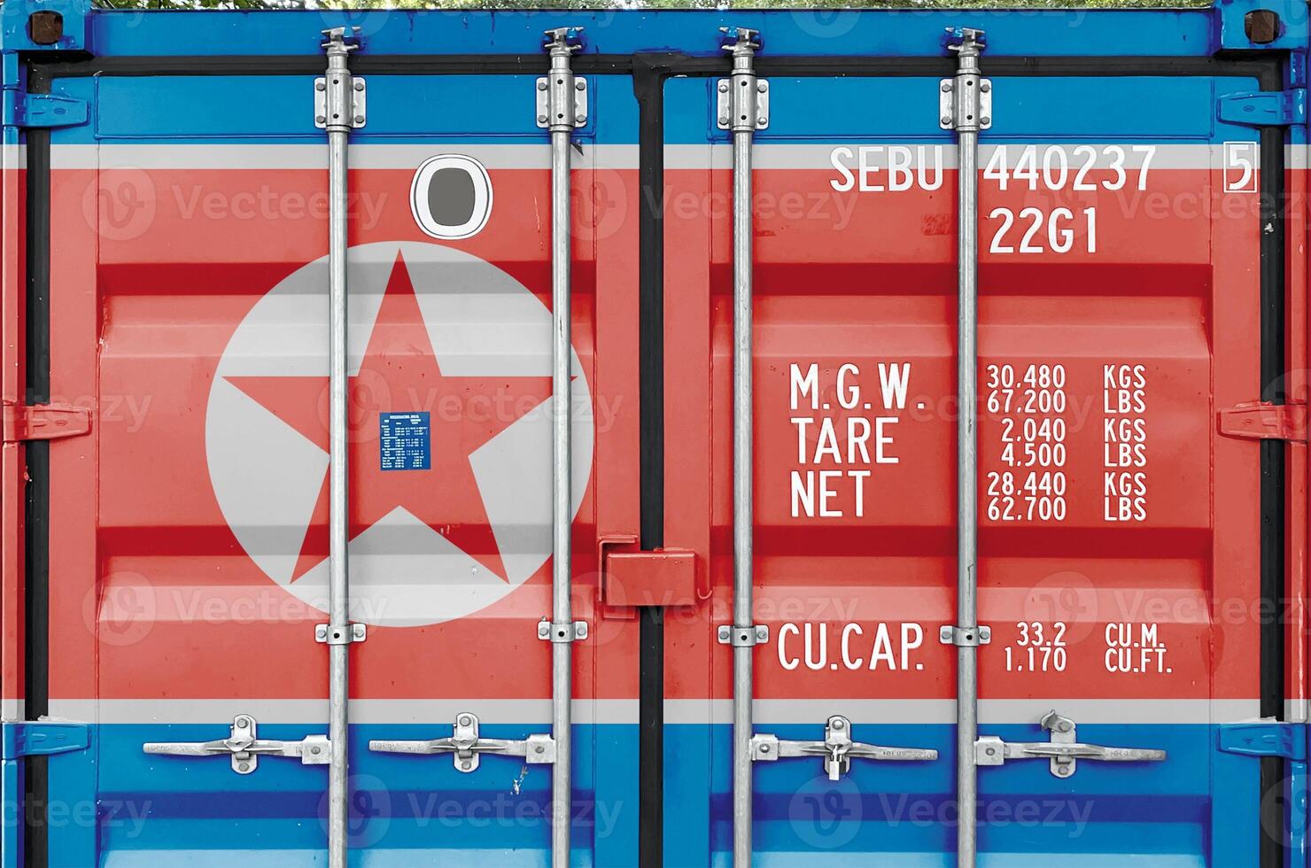 North Korea flag depicted on metal doors of shipping cargo container outdoors in docks area photo
