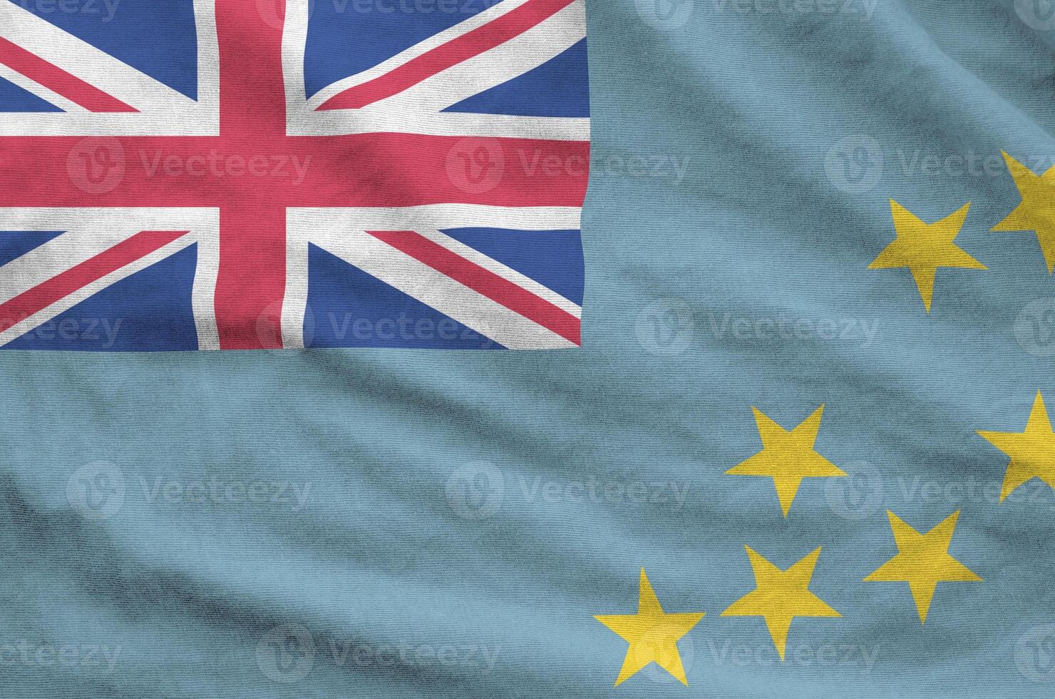 Tuvalu flag depicted on folded wavy fabric of old cloth photo