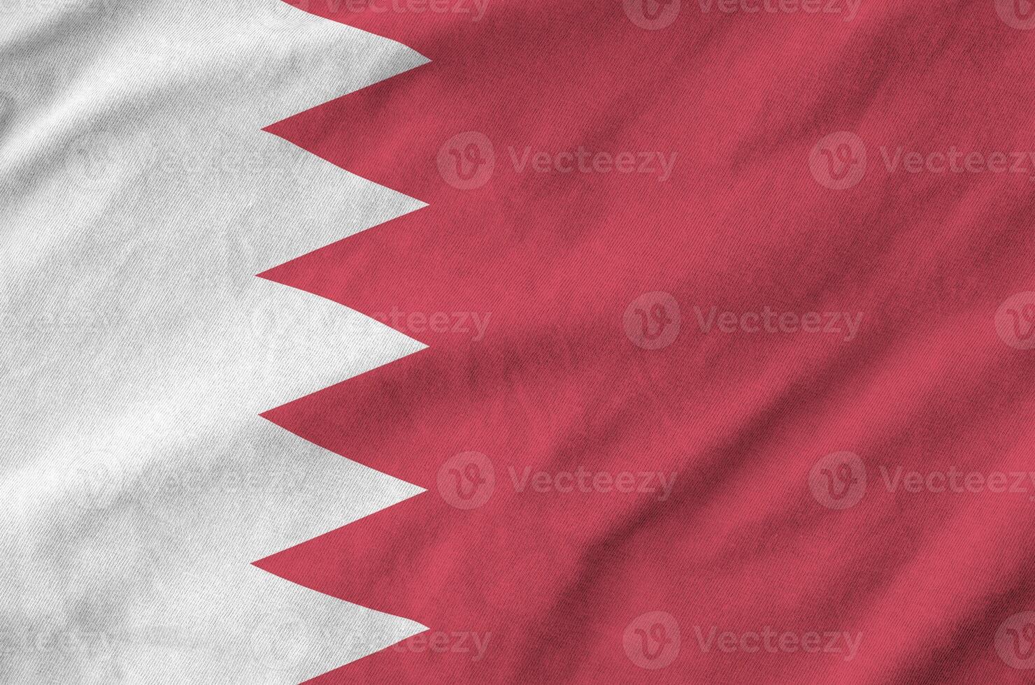 Bahrain flag depicted on folded wavy fabric of old cloth photo