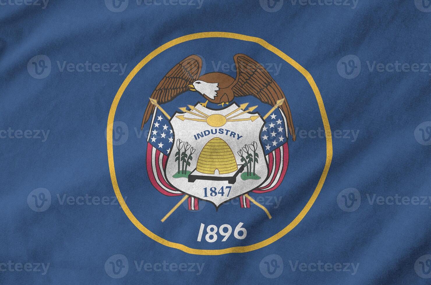 Utah US state flag depicted on folded wavy fabric of old cloth photo