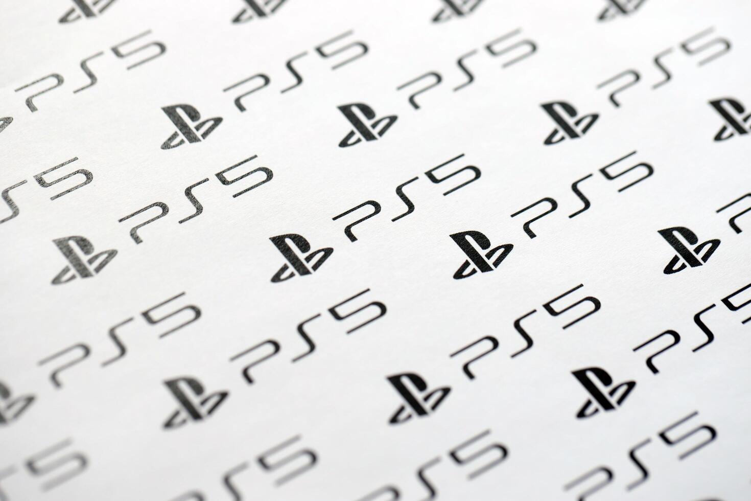 KYIV, UKRAINE - JUNE 26, 2024 Sony Playstation 5 console logo repeating many times on white paper background banner photo