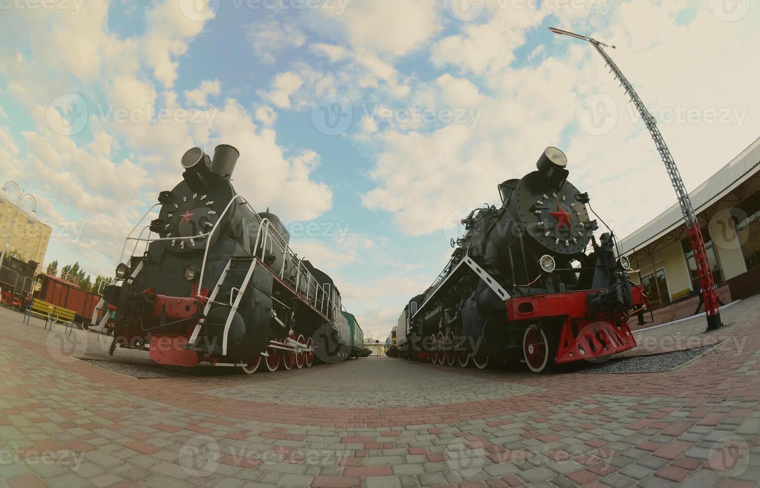 Photo of old black steam locomotives of the Soviet Union. Strong distortion from the fisheye lens