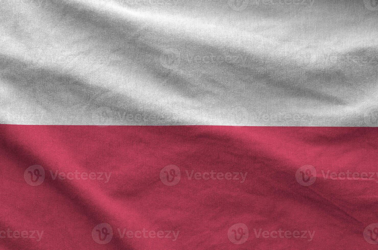 Poland flag depicted on folded wavy fabric of old cloth photo