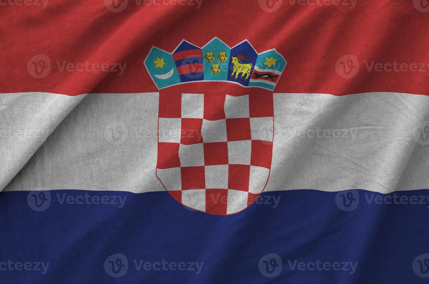 Croatia flag depicted on folded wavy fabric of old cloth photo
