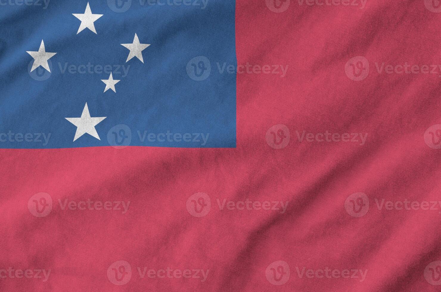 Samoa flag depicted on folded wavy fabric of old cloth photo