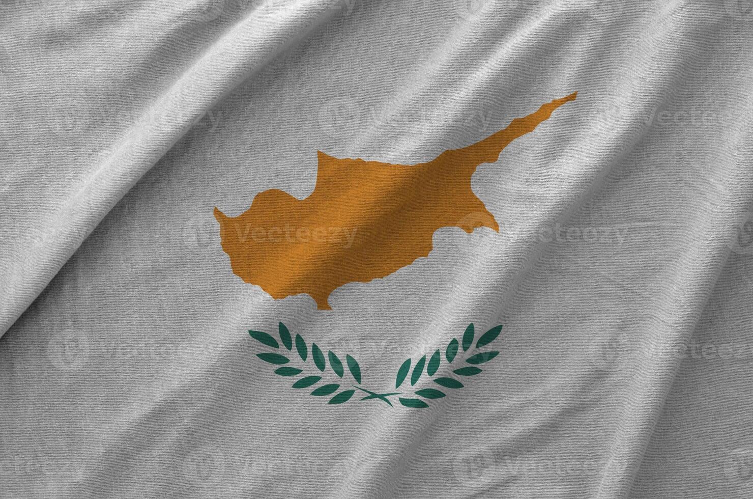 Cyprus flag depicted on folded wavy fabric of old cloth photo