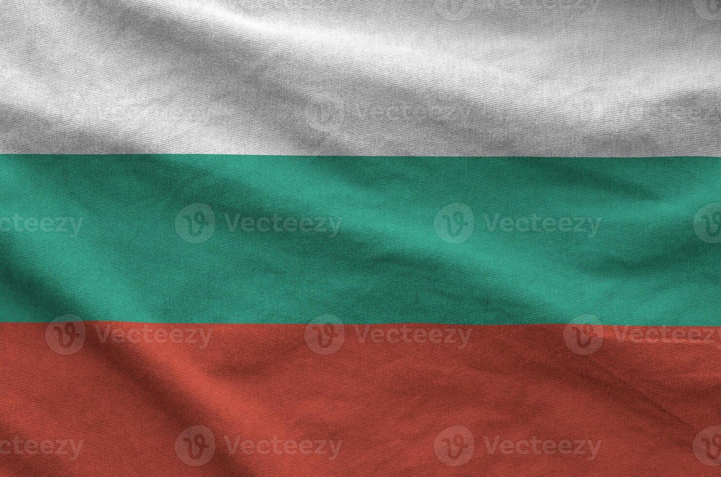 Bulgaria flag depicted on folded wavy fabric of old cloth photo