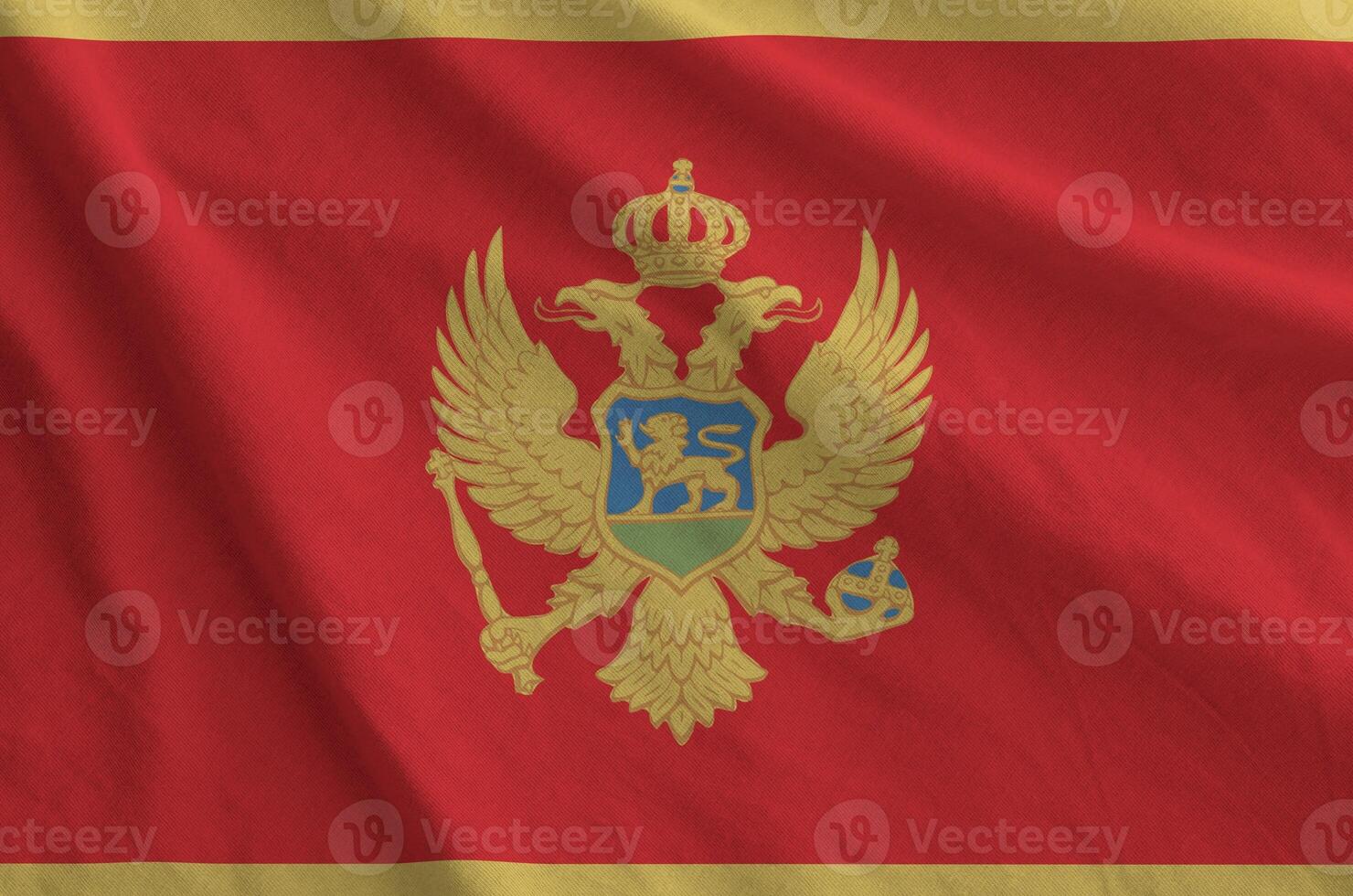 Montenegro flag depicted on folded wavy fabric of old cloth photo