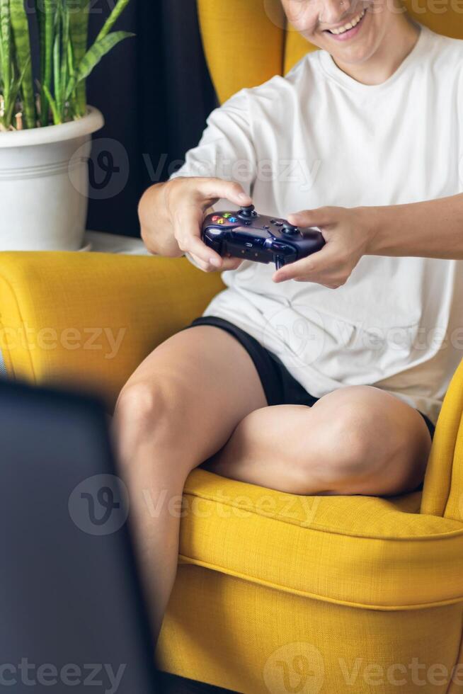 The woman is holding a black jostic, joystick, navigation key, cursor buttons, navigation control. She plays the game on the console. vertical photo