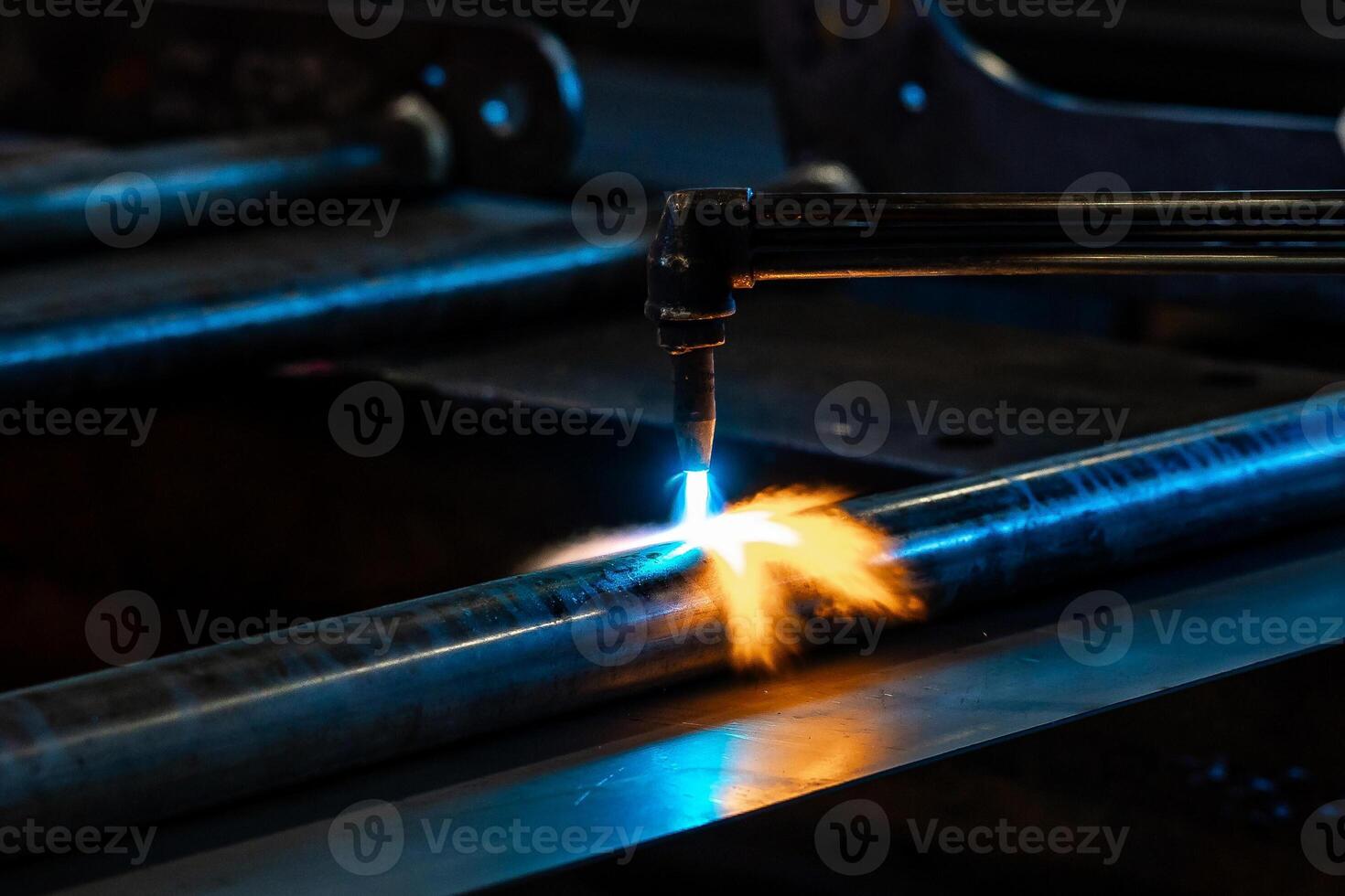 Heating up of metal construction with acetylene and oxygen burner in process of flame straightening with visible red colour of heated metal photo